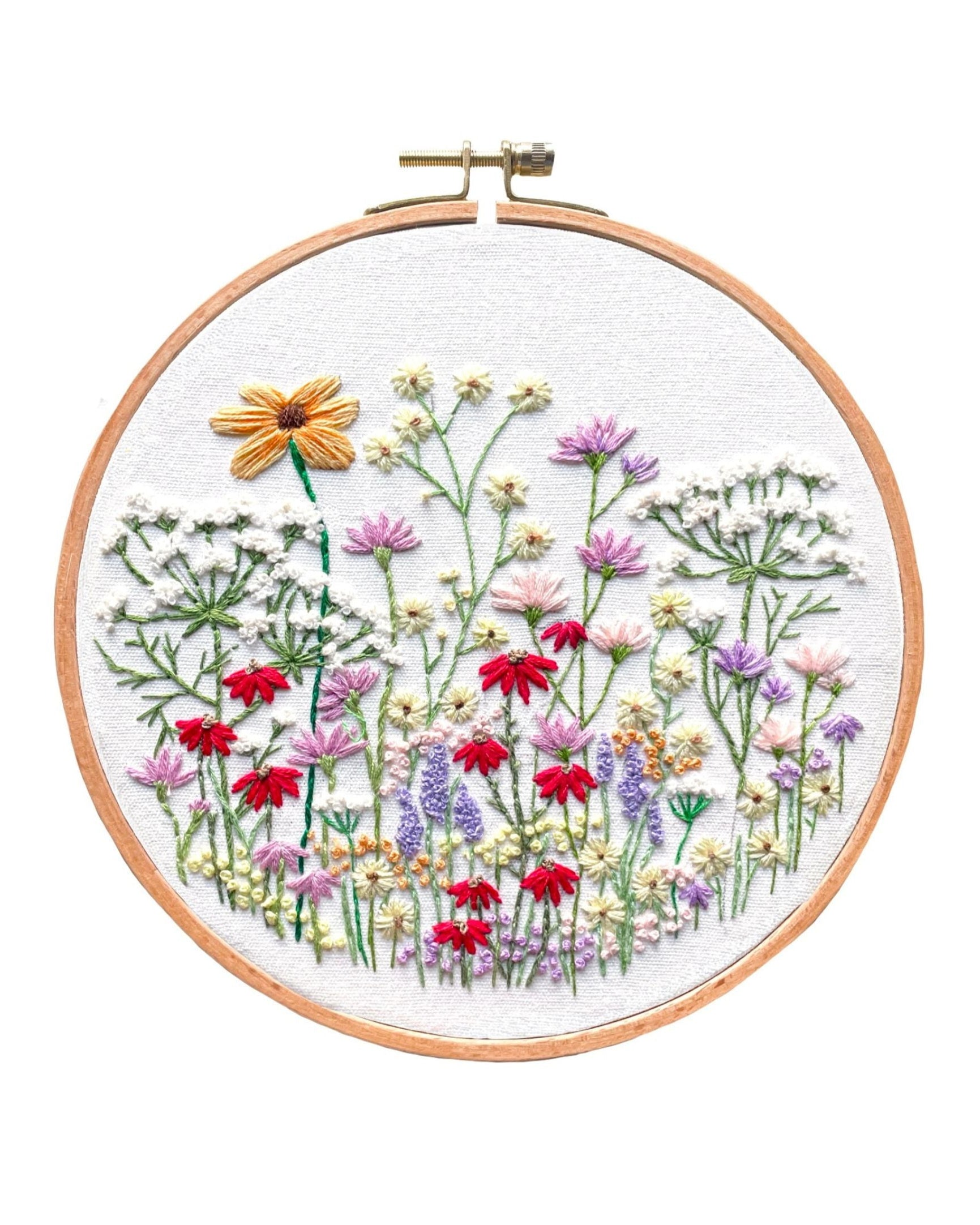 Meadow Wildflowers embroidery hoop featuring colorful floral design with red, purple, and yellow blooms on white fabric background
